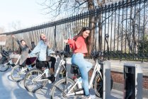 Philippine friends women in a bycicle station in Retiro Park Madrid — Stock Photo