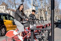 Jeune couple obtenir un vélo pour une balade à vélo à Barcelone — Photo de stock