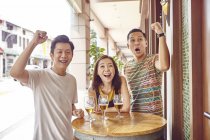 Молодые азиатские друзья аплодируют вместе в баре — стоковое фото