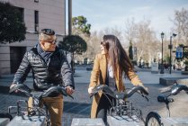 Asian Chinesse couple of honeymooner tourists riding a bike in Plaza Ramales in Madrid, Spain — Stock Photo