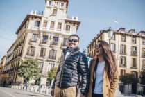 Chinese couple walking around Plaza Ramales, Spain — Stock Photo