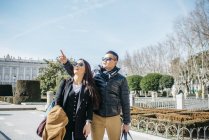 Asian Chinesse honeymooners tourist walking around la almudena ana palacio real in Madrid, Spain — Stock Photo