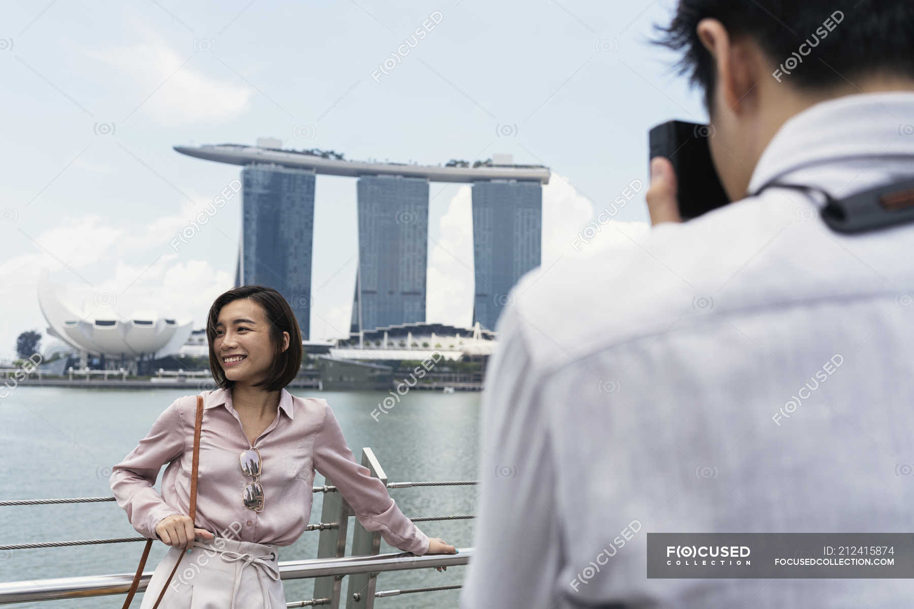 Man Taking Photo Of Asian Woman In Singapore — Couple, Casual - Stock 