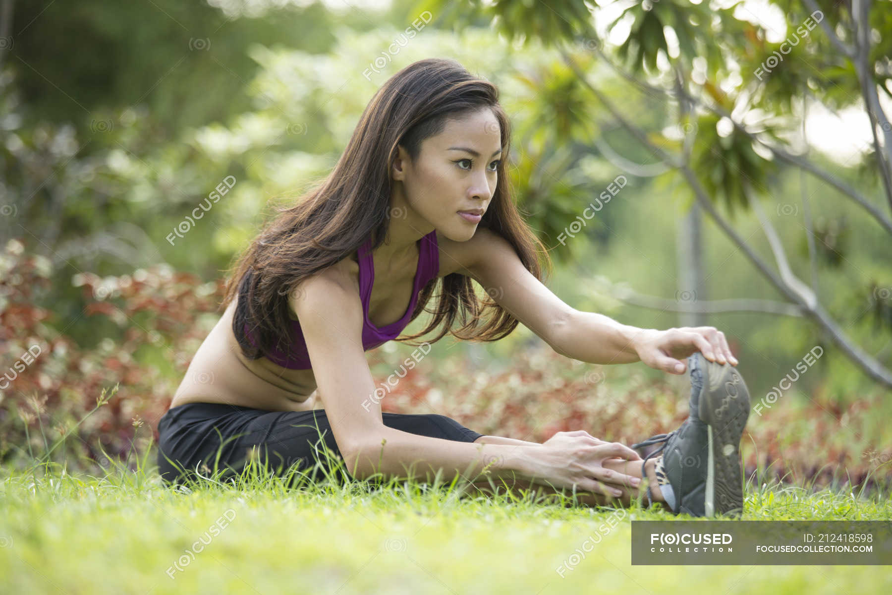 A Young Asian Woman Is Doing Yoga In The Park At Marina Bay ...