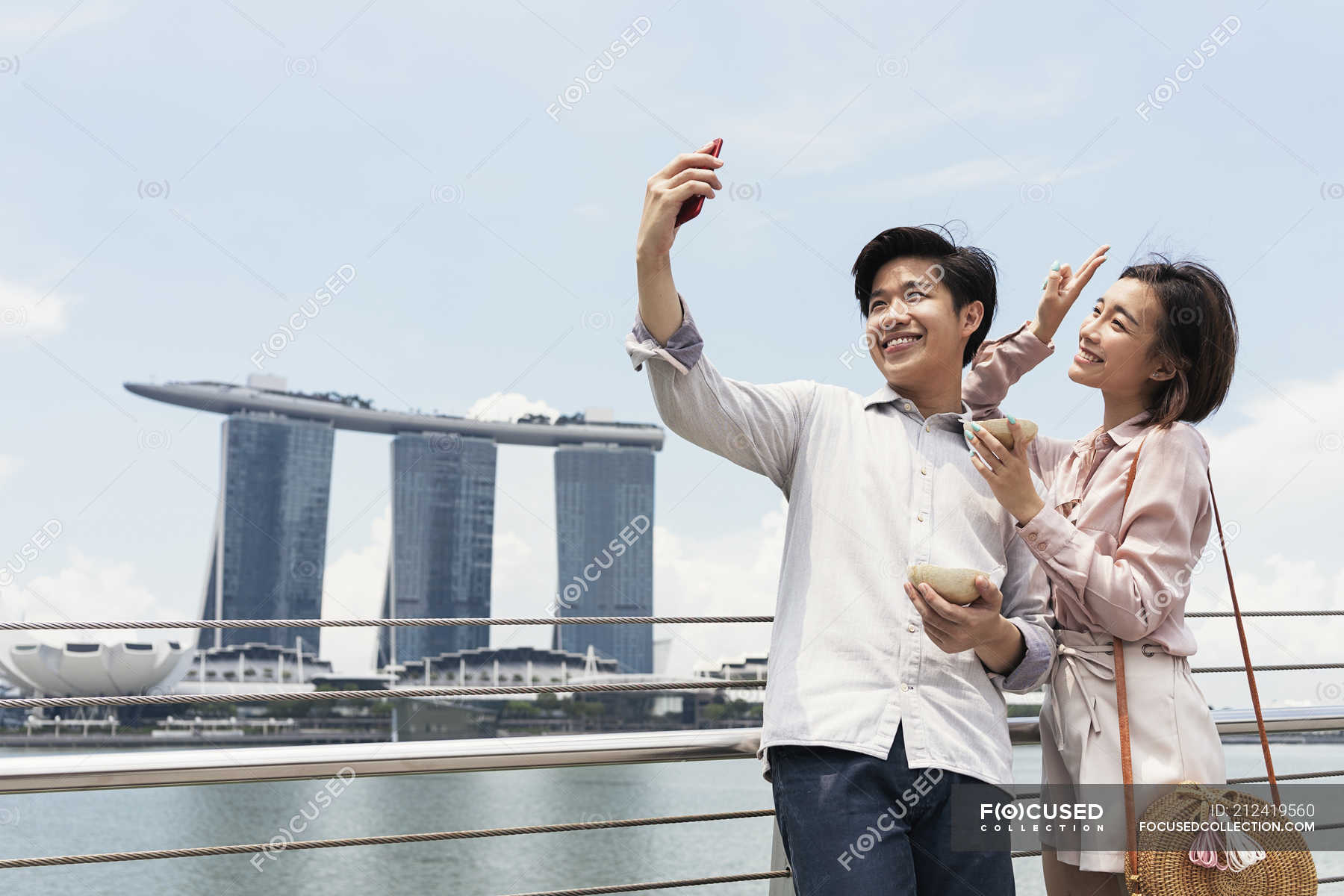 Young asian couple taking selfie in Singapore — together, people ...