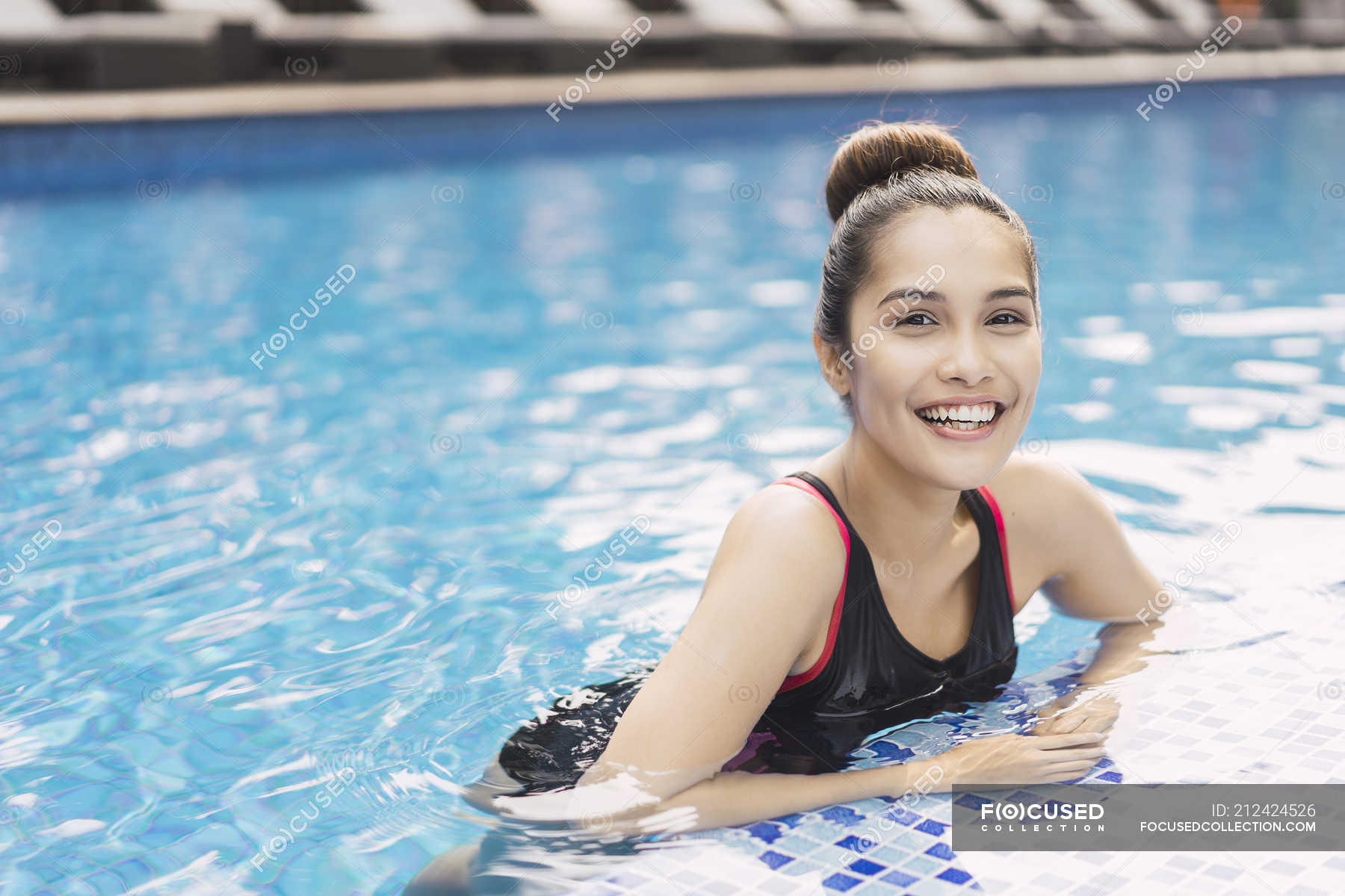 Young Beautiful Asian Woman In Swimming Suit Having Fun In Pool