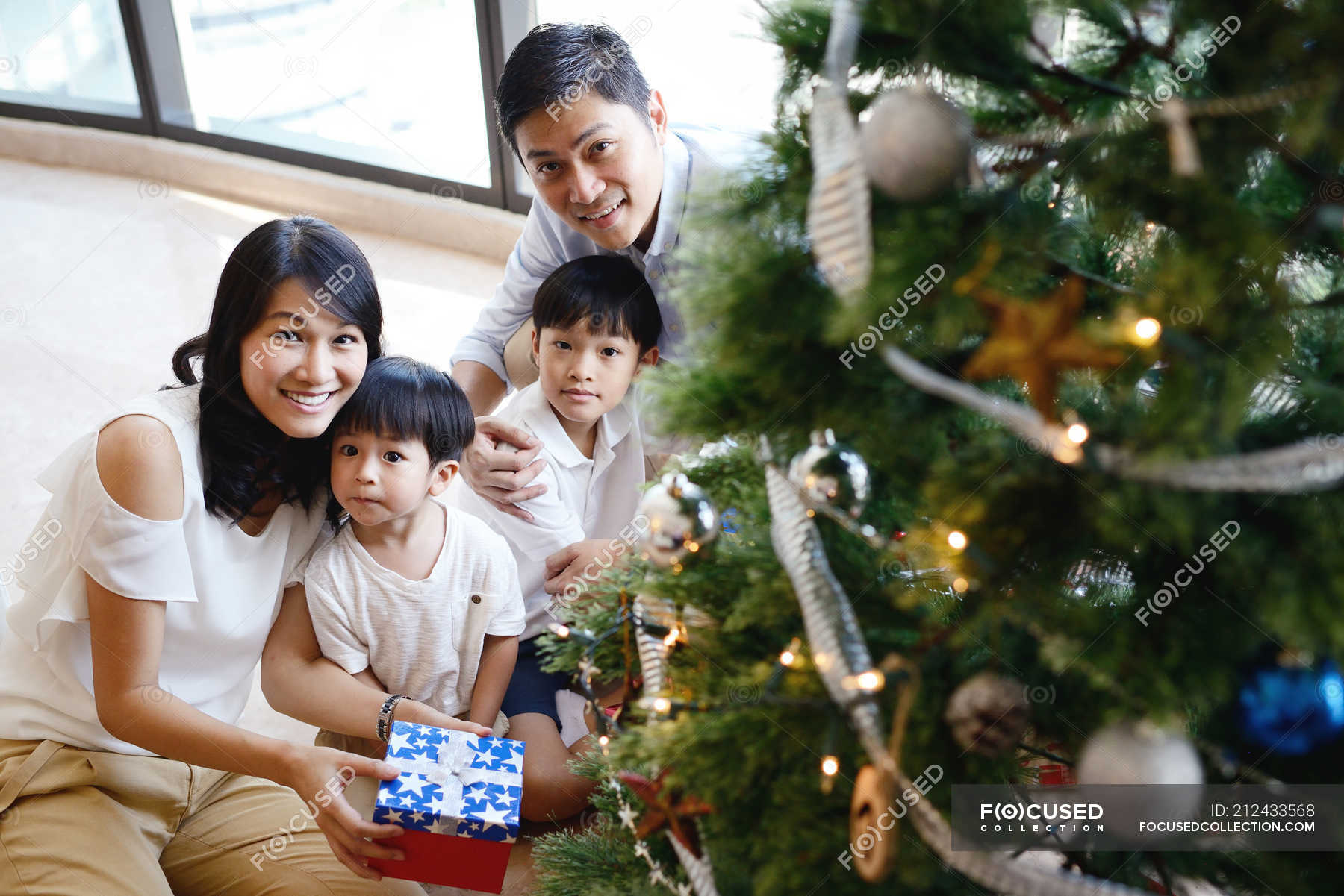 Asian family celebrating Christmas holiday — children, gifts - Stock ...