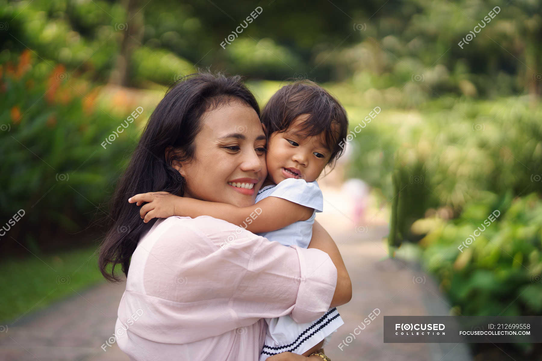 Cute Asian Mother And Daughter Hugging In Park Woman Family Stock