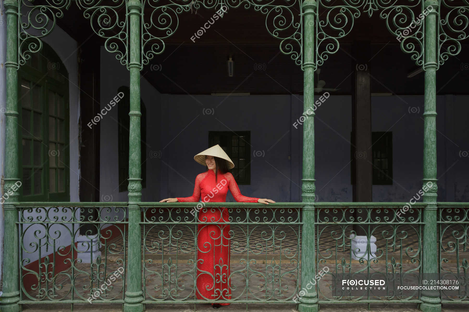 Vietnamese Woman Wearing Conical Hat Standing On A Balcony In Hoi An In Her Ao Dai — Female 8353