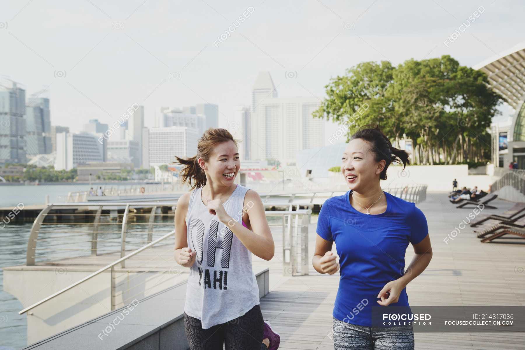 Young sporty asian women running at park — copy space, city - Stock ...