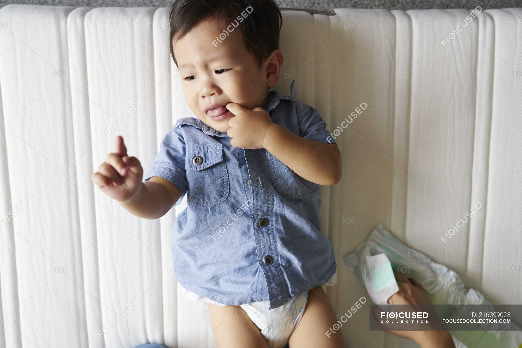 Baby boy getting his diapers changed — small, people Stock Photo