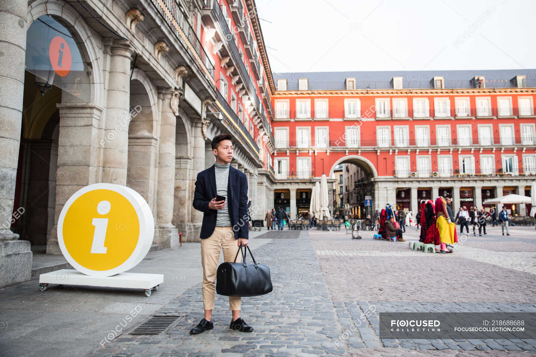 Casual Young Chinese Man At Plaza Mayor In Madrid Spain Young Adult Looking Away Stock Photo
