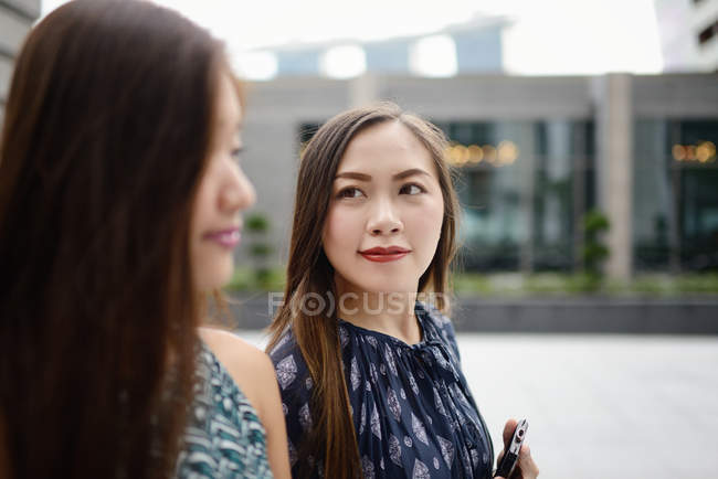 Happy beautiful asian women walking on street — Stock Photo