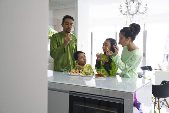 Young asian family celebrating Hari Raya together at home — Stock Photo