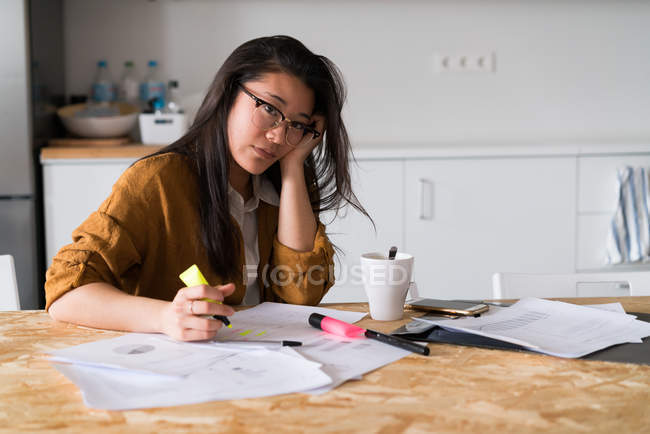 Chinese woman at home working looking at the camera — Stock Photo
