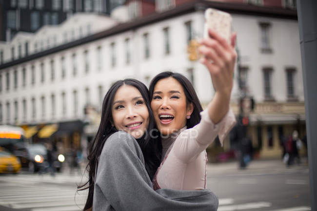 Two asian girlfriends in meat packing . — Stock Photo