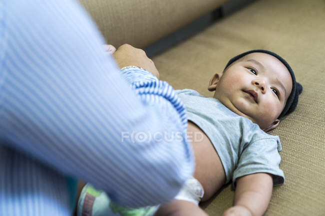 Baby getting the diaper changed at home — Stock Photo