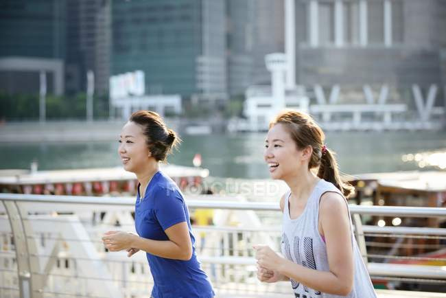 Two sporty women running outdoors — Stock Photo