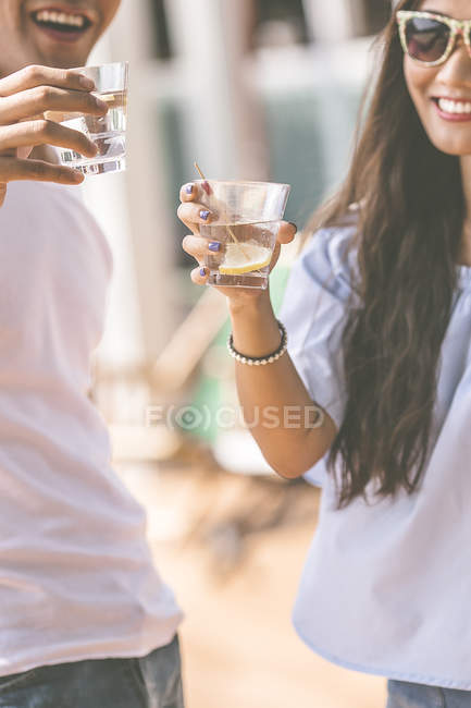 Happy couple cheering with cocktails, closeup — Stock Photo