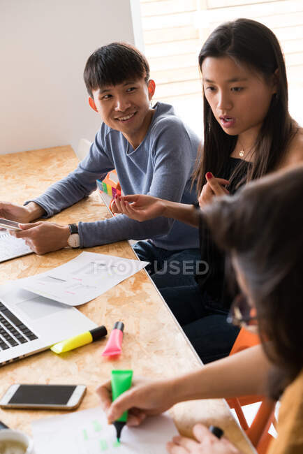 Young Chinese Entrepreneurs having a discussion in office — Stock Photo