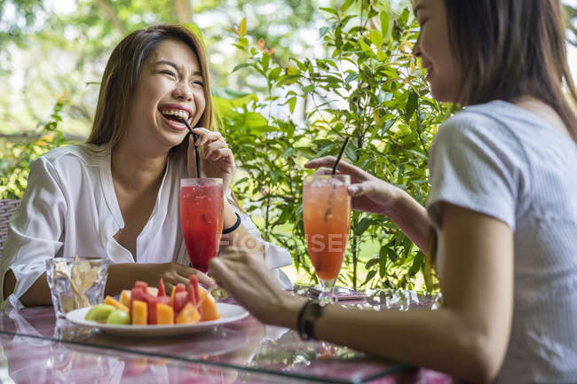 Two young ladies enjoying the fruits. — Stock Photo