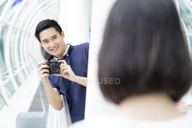 Young asian couple taking photo — Stock Photo