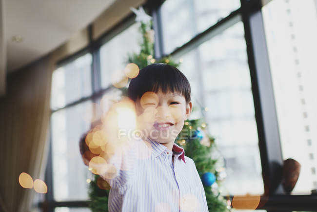 Asian family celebrating Christmas holiday, boy with firework sparkler — Stock Photo