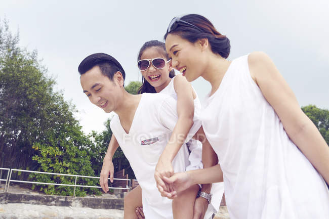 Happy asian family spending time together on beach — Stock Photo