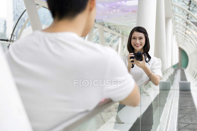 Young attractive asian couple together taking photo on camera — Stock Photo