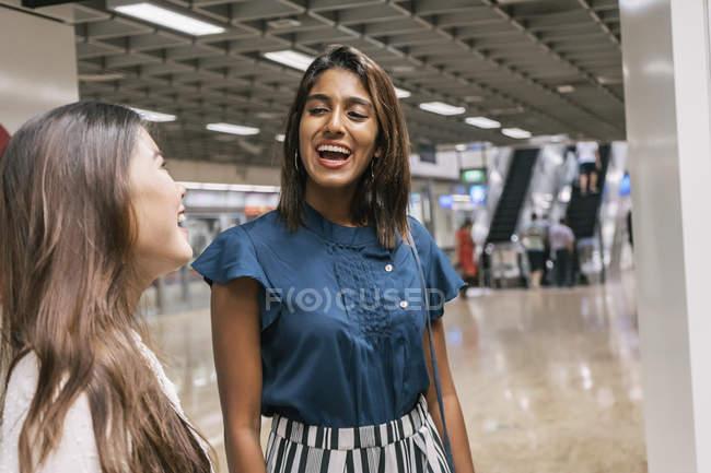 Young casual asian girls at subway — Stock Photo