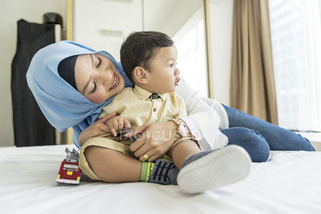 Mother and son hugging in room — Stock Photo