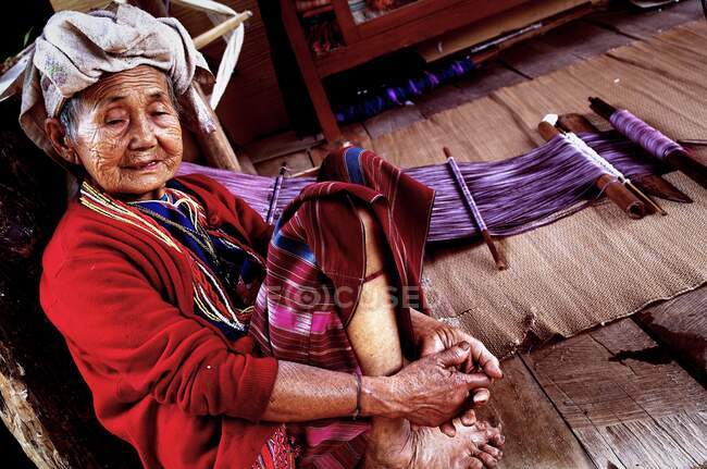 This Pakayor grandma at Mae Klangluang village, Doi Inthanon, Chiang Mai is taking a break from weaving. — Stock Photo