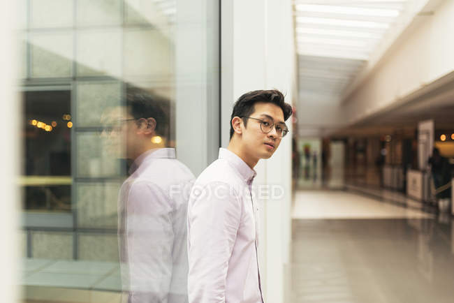 Young casual asian posing at shopping mall — Stock Photo