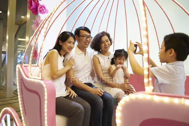 RELEASES Happy young asian family taking photo together — Stock Photo