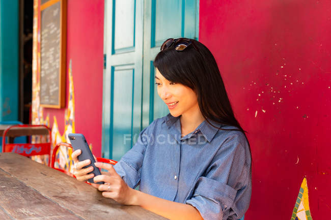 Attraente adulto asiatico donna utilizzando smartphone — Foto stock