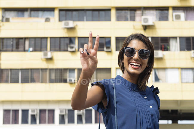 Young casual asian girl posing at camera — Stock Photo