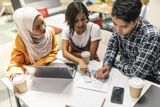 Young multicultural business people at work in modern office — Stock Photo
