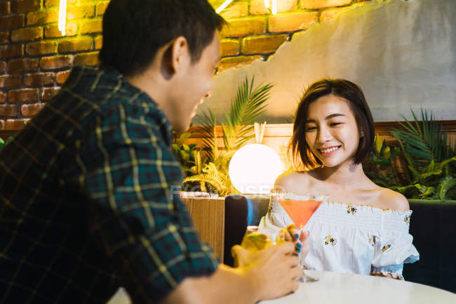 Jovem asiático casal na data no confortável bar — Fotografia de Stock