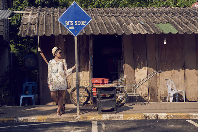 Young woman waiting at a bus stop in Koh Chang, Thailand — Stock Photo