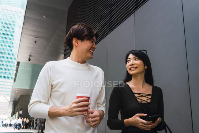 Young asian couple walking on street together — Stock Photo