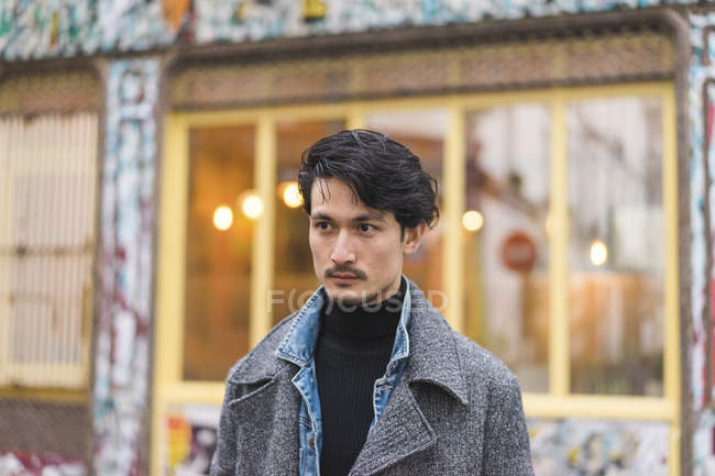 Young attractive casual asian man portrait on street — Stock Photo