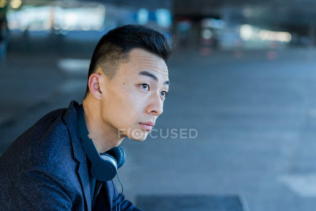 Portrait of young asian man, side view — Stock Photo