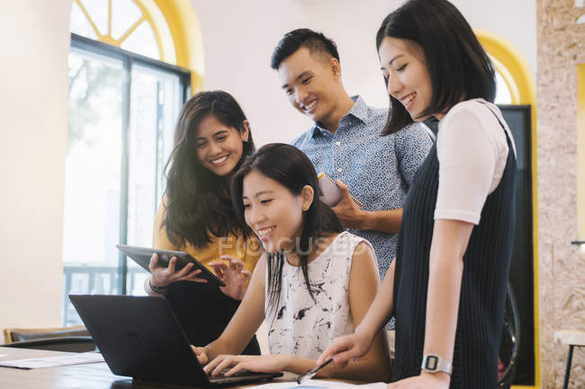 Young asian people working in creative modern office — Stock Photo