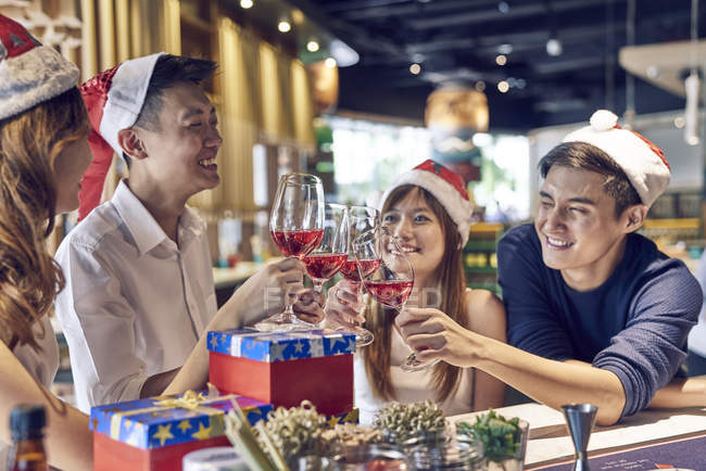 Company of young asian friends together celebrating christmas — Stock Photo