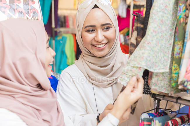 Young muslim women shopping for Hari Raya at a bazaar — Stock Photo