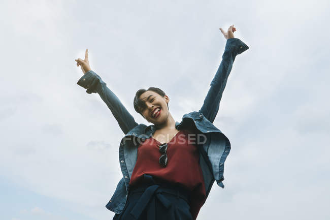 Young Malay lady in Singapore enjoying herself outdoors with natural lighting. — Stock Photo
