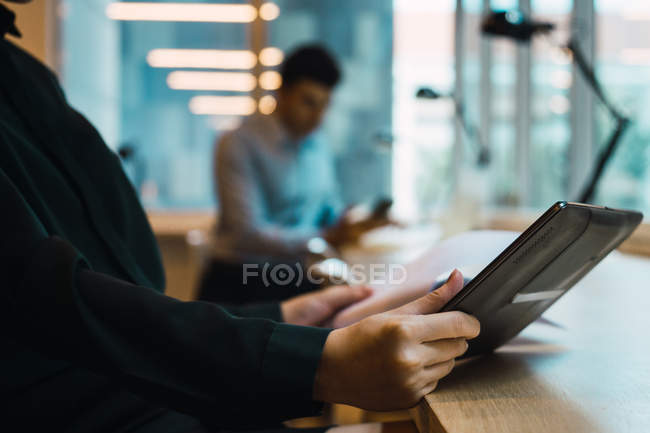 Cropped image of business woman using tablet — Stock Photo