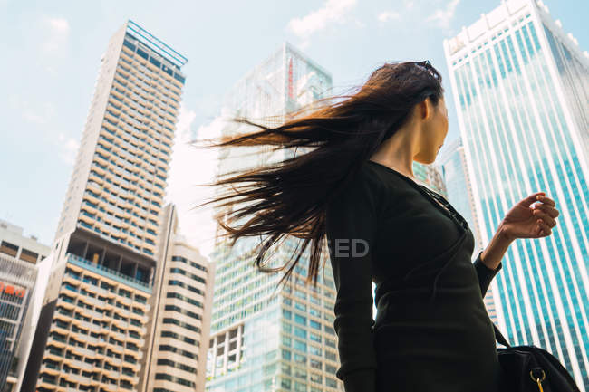 Young asian woman on city street — Stock Photo