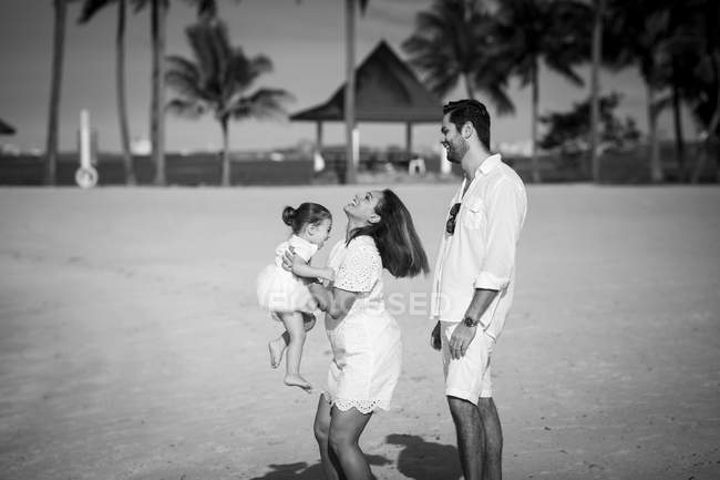 Happy caucasian family on beach, monochrome image — Stock Photo