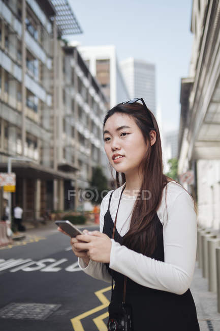 Chinesin mit langen Haaren fährt in Stadt gegen Straße — Stockfoto